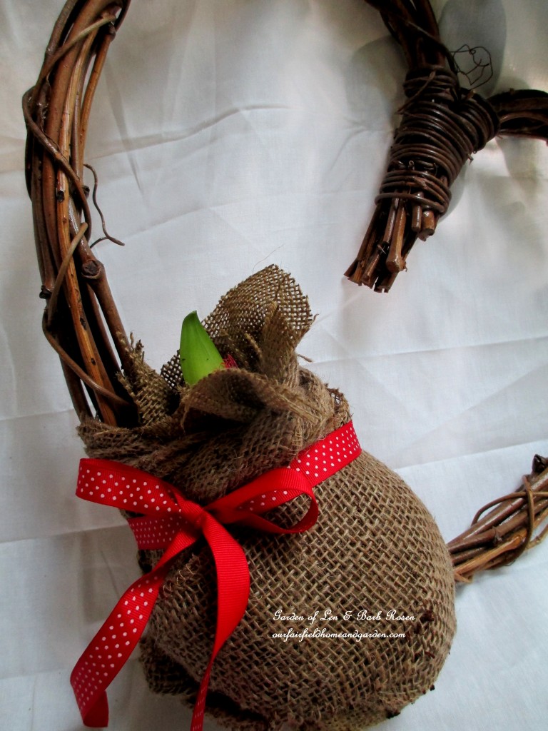 attach the burlap wrapped ball to the wreath with floral wire, then add a ribbon http://ourfairfieldhomeandgarden.com/diy-amaryllis-heart-wreath/