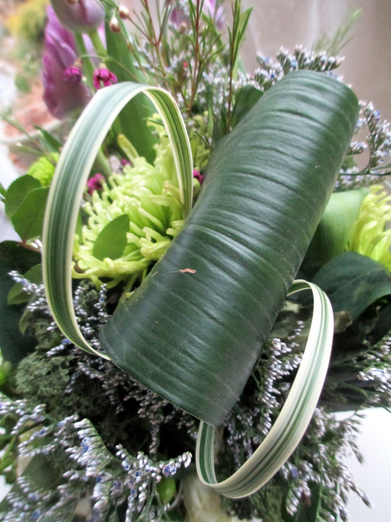 Create special floral accents by folding large leaves over, twisting the ends together, and inserting in the oasis!