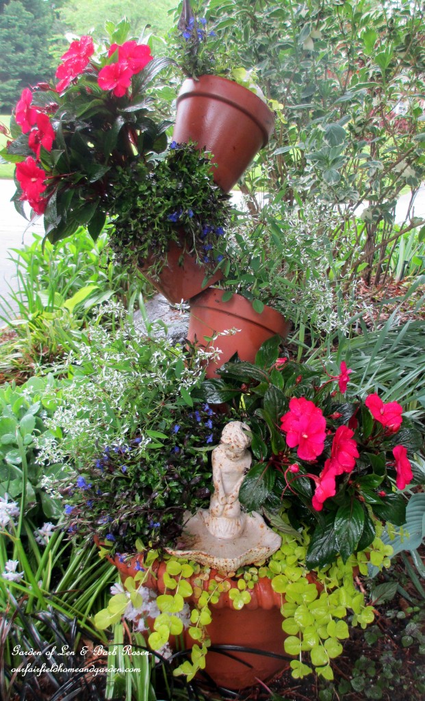 Tipsy Pots planted with Creeping Jenny, Euphorbia, New Guinea Impatiens, and Lobelia.